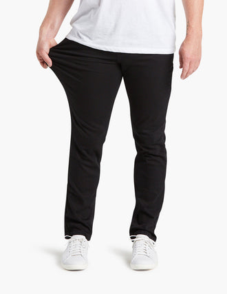 Black stretch jeans being worn, showcasing flexibility and comfort