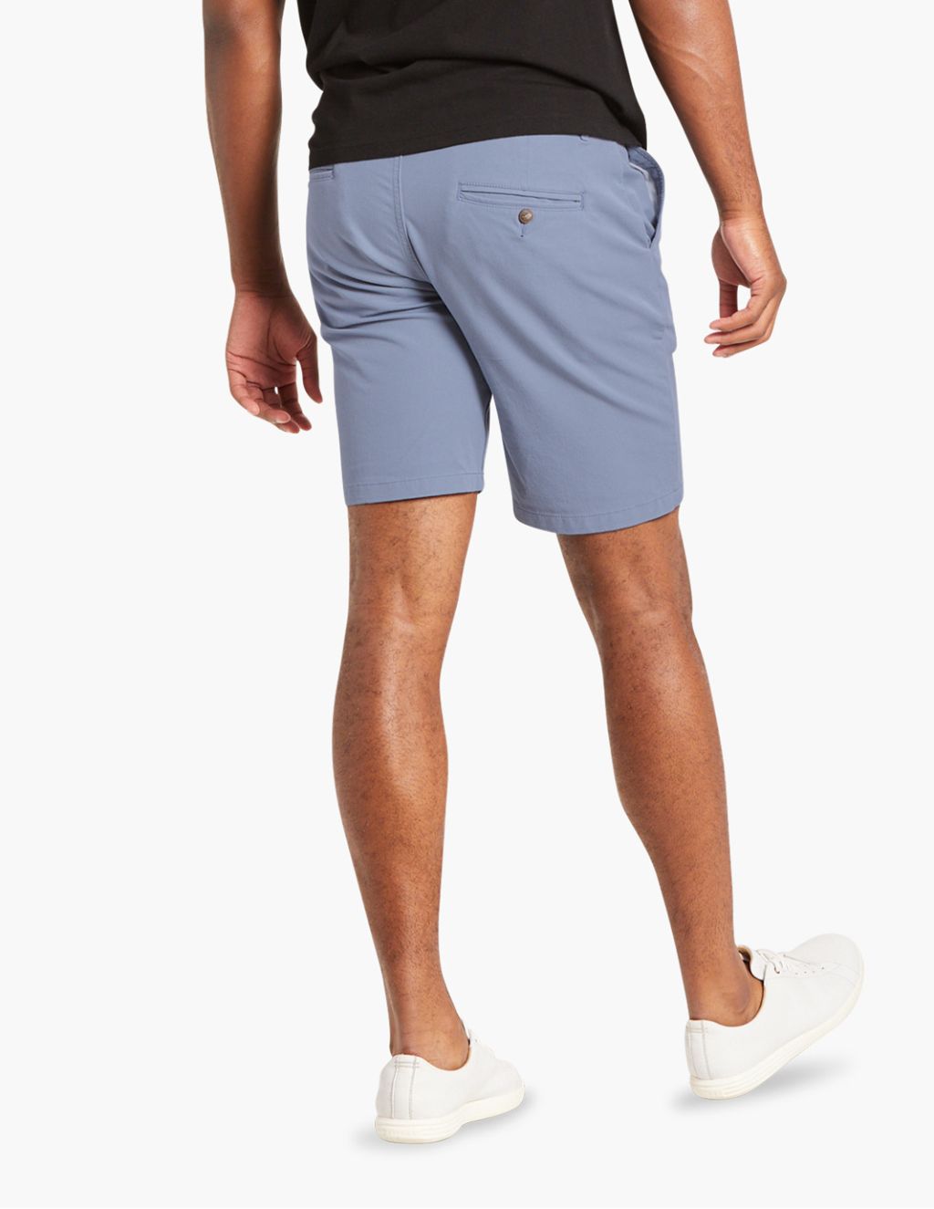 Back view of a man wearing light blue Marinas shorts and white sneakers