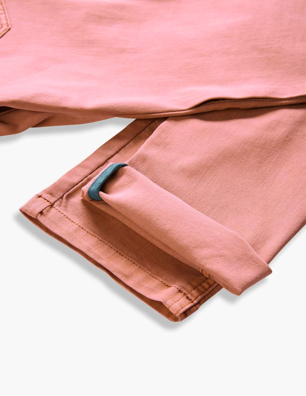 Close-up of folded pink pants with a blue tab detail on the cuff