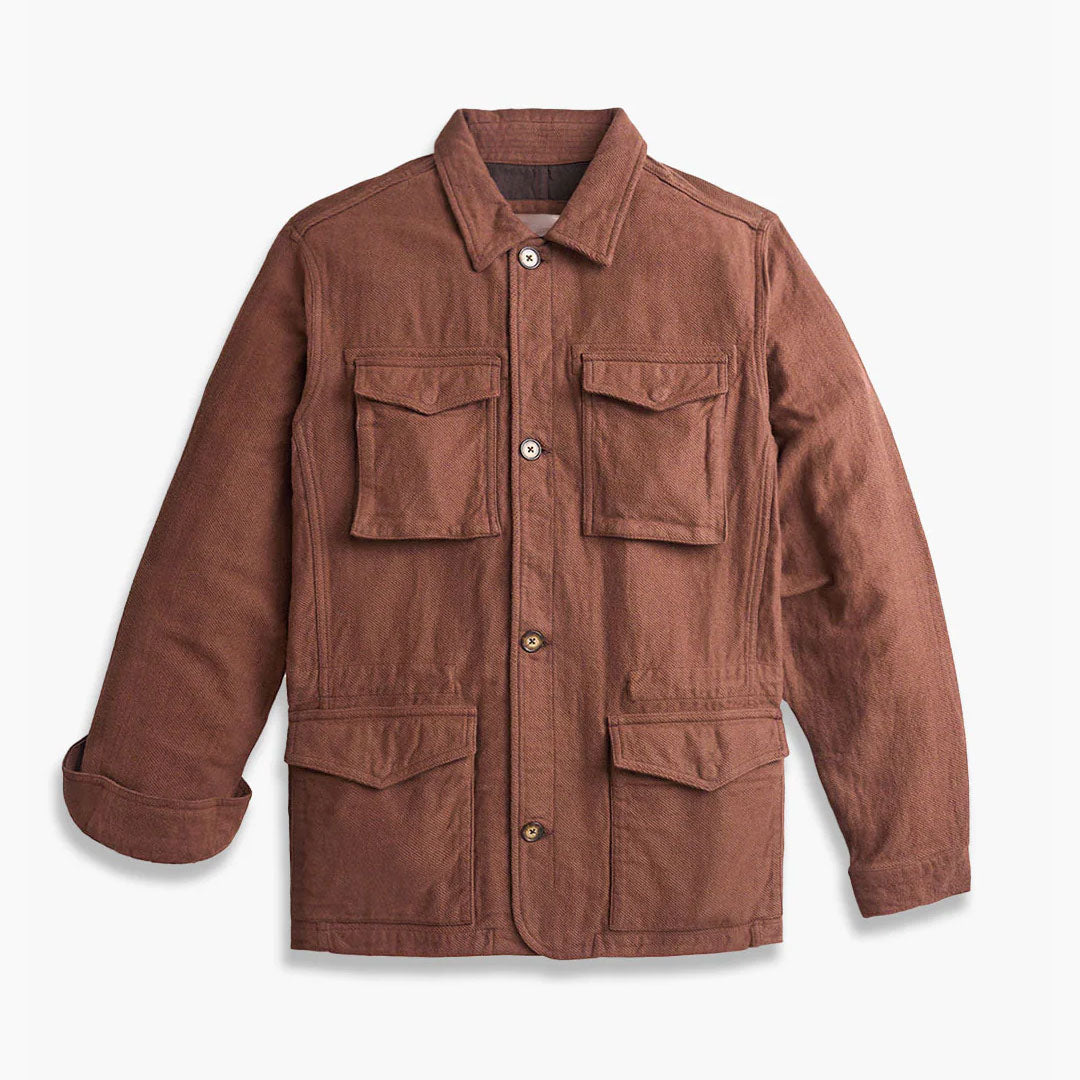 Brown corduroy field jacket with four flap pockets, button-front closure, notch collar and long sleeves.
