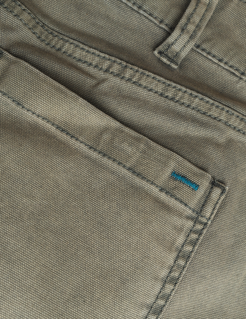 Close-up of Carters Olive utility pant pocket showcasing blue bartack reinforcement and double stitching on canvas fabric