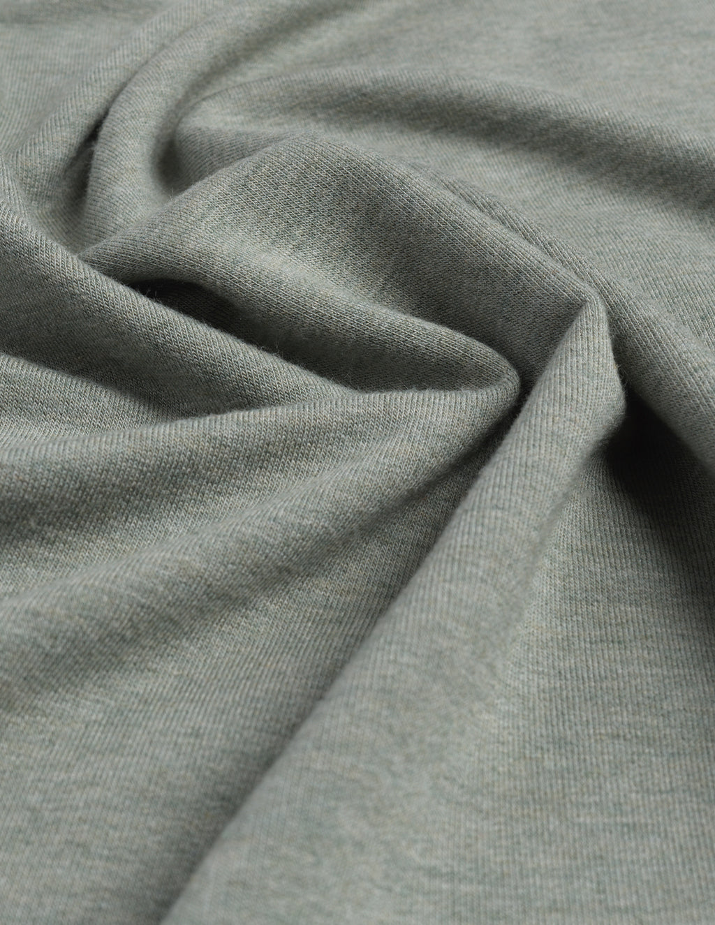 Washed green polo shirt fabric detail.