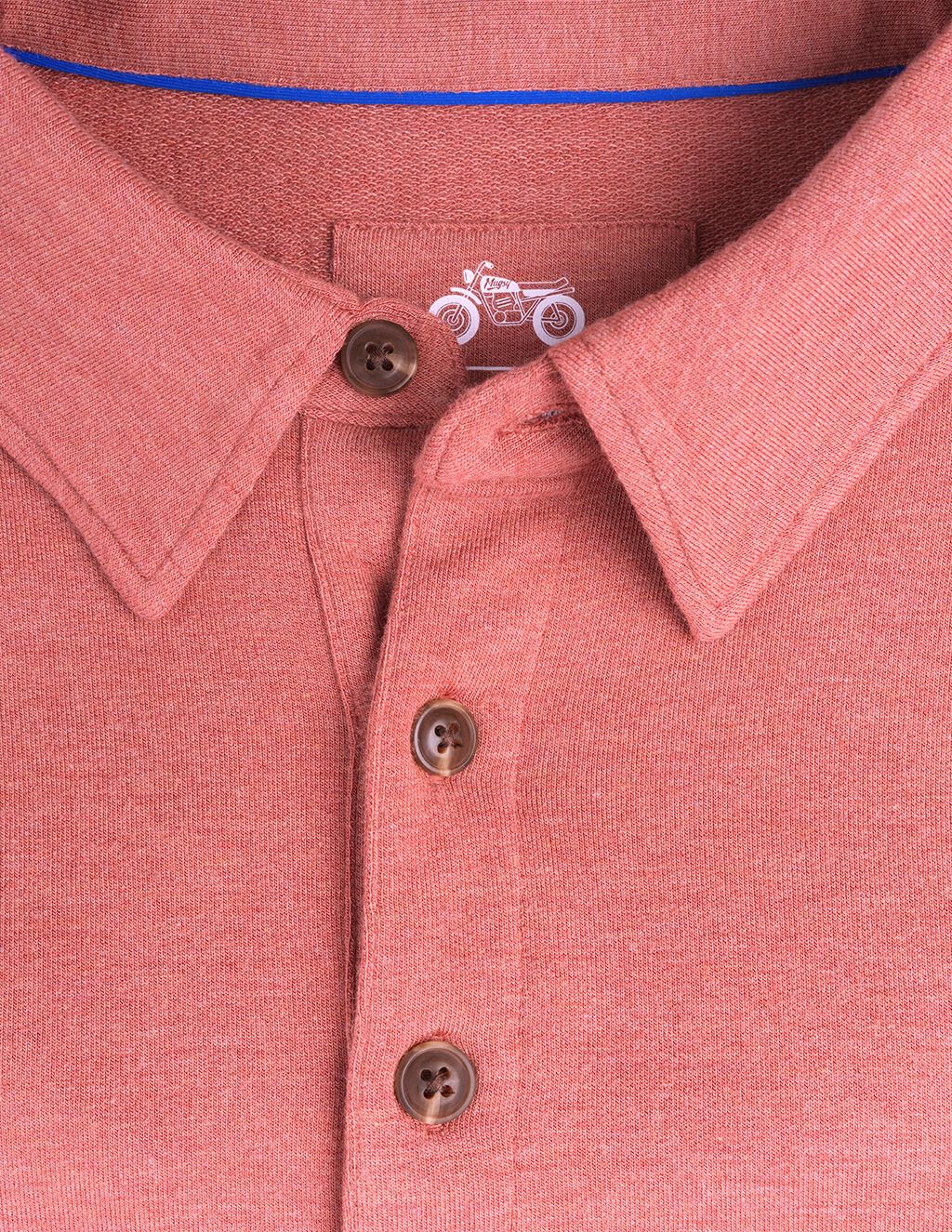 Washed red polo shirt collar detail.