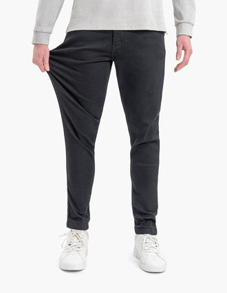 Model wearing Squid Inks Tapered jeans, showcasing flexibility and fit.