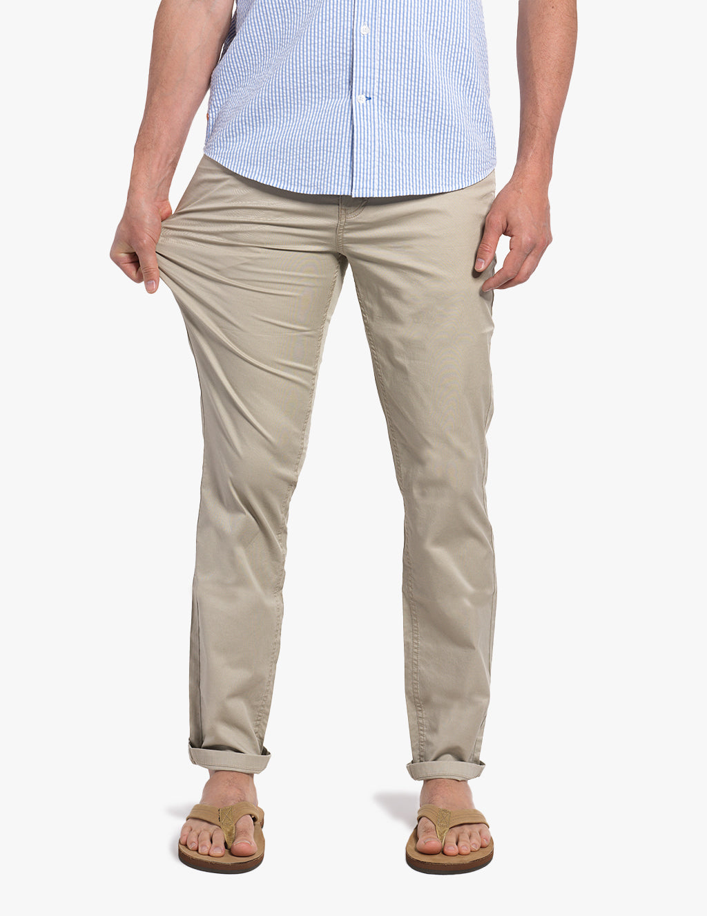 A person wearing Commanders 5-Pocket Chinos in khaki, standing with hands on the pants.