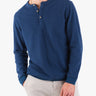 Model wearing a navy waffle-knit henley shirt with buttons