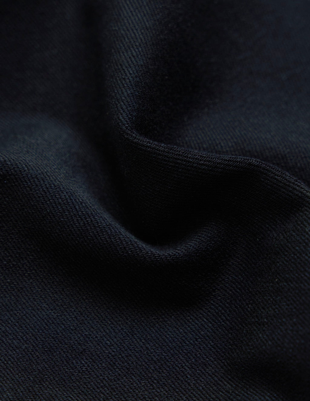 Dark navy knit fabric close-up showing ribbed texture and soft folds