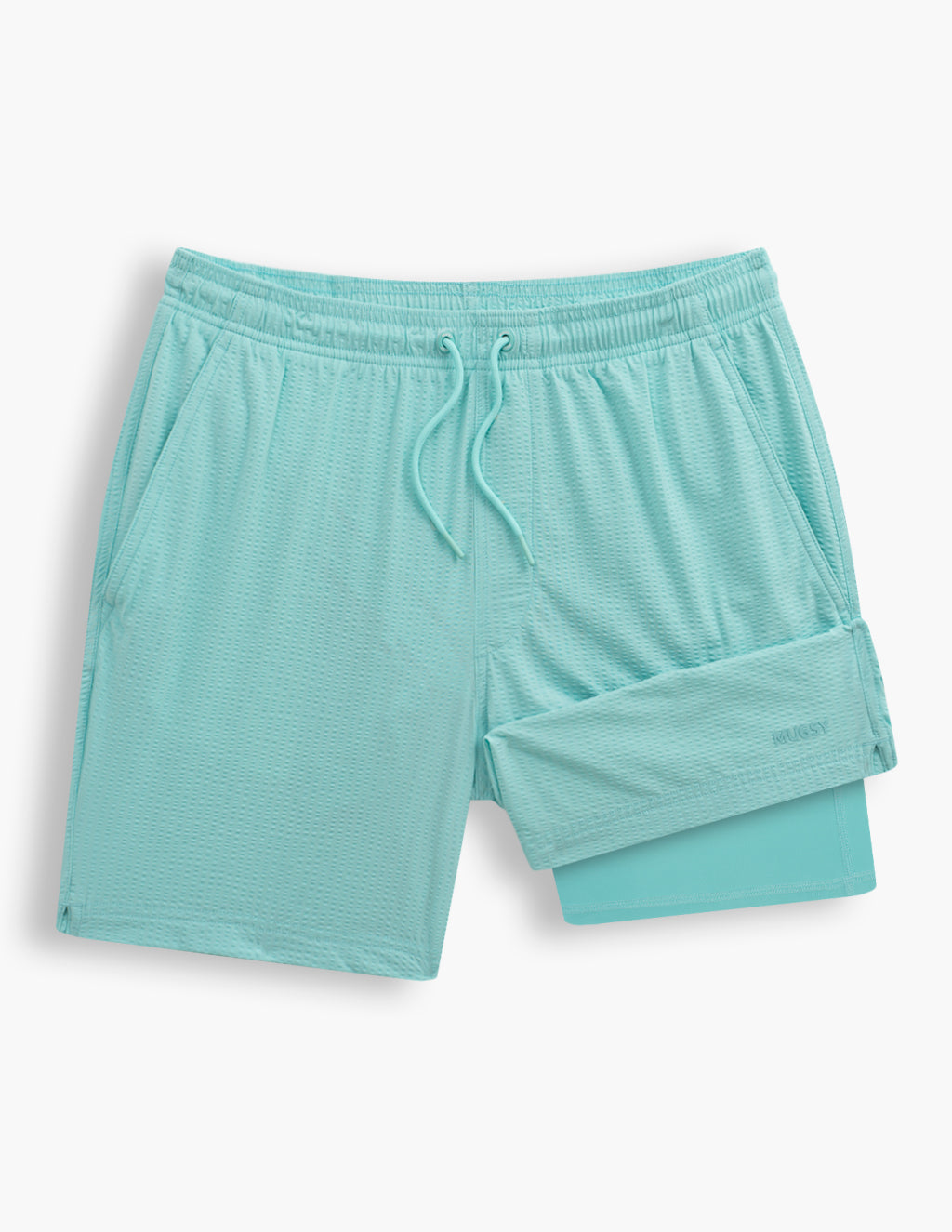 Flat lay of men's Glaciers aqua swim shorts showcasing textured fabric and exposed inner liner on white background