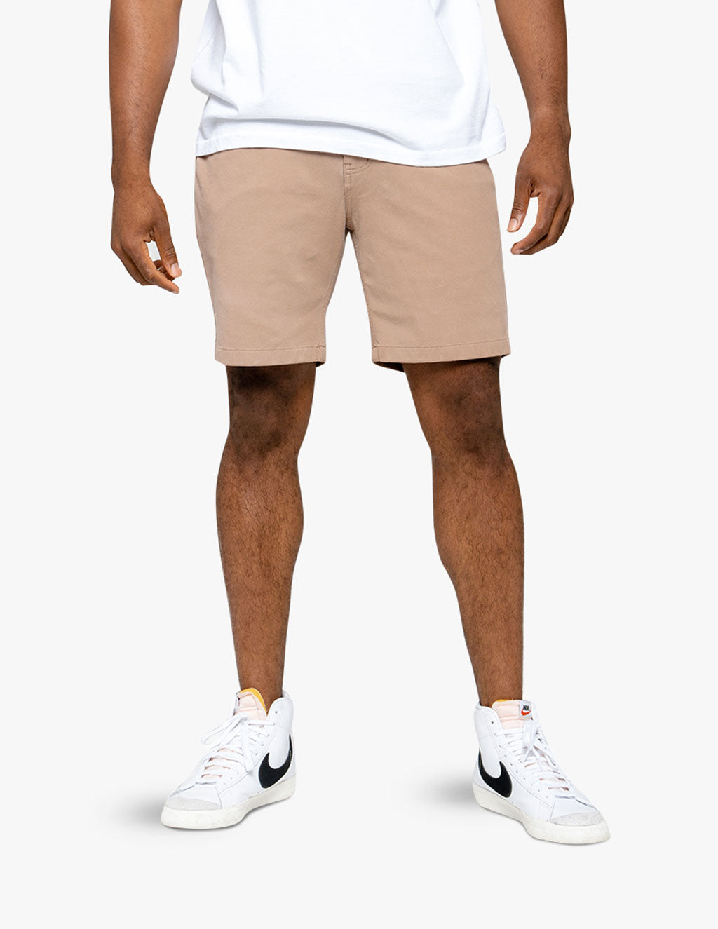 Model wearing Washed Belmonts shorts in khaki color, standing with hands at sides.