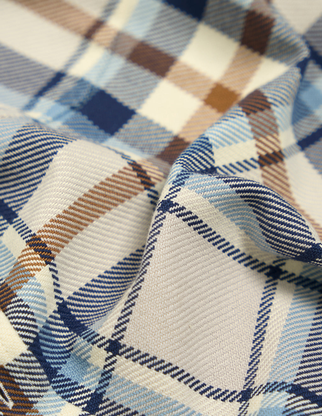Blue, brown, and cream plaid woven fabric with diagonal twill texture and folded drape.
