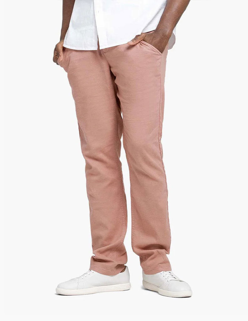 Model wearing pink pants with pockets and white sneakers