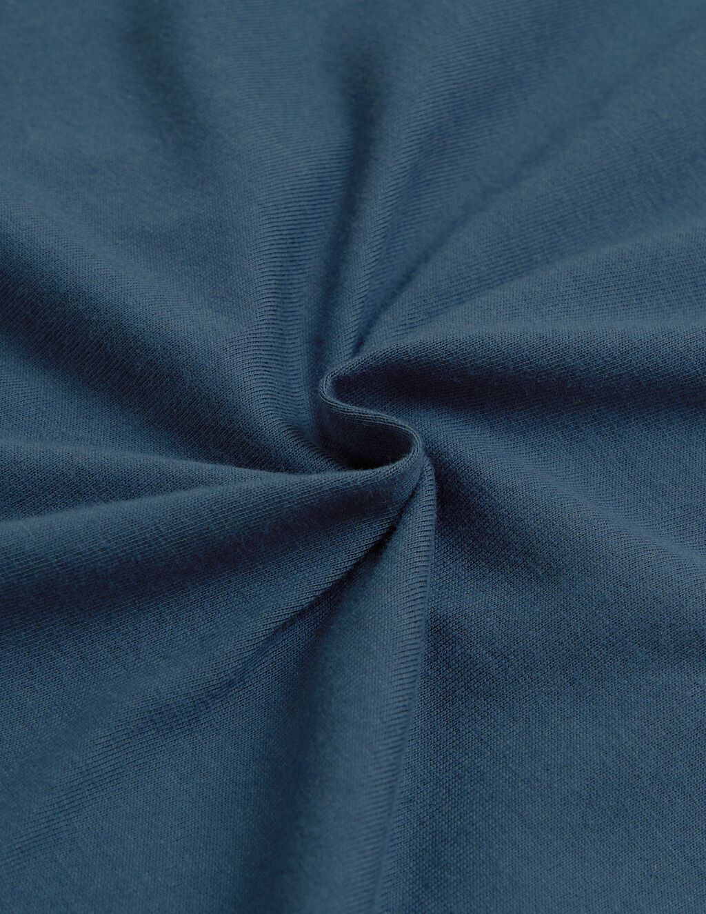 Dark teal knit fabric twisted into a central spiral, highlighting ribbed texture