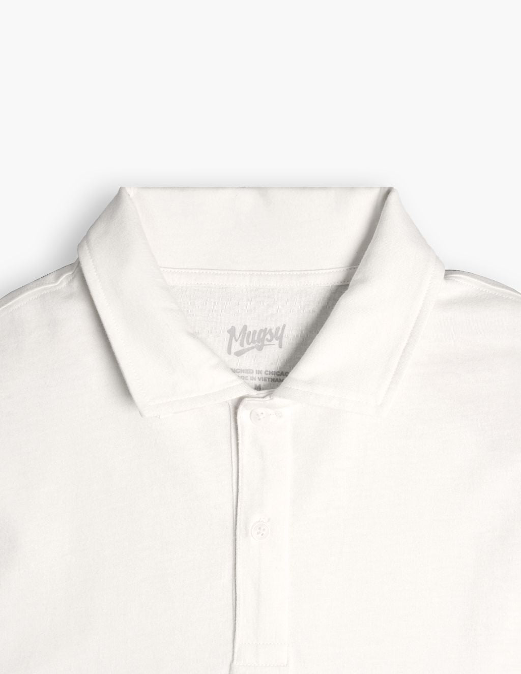 White polo shirt collar and placket with visible "Mugsy" label.