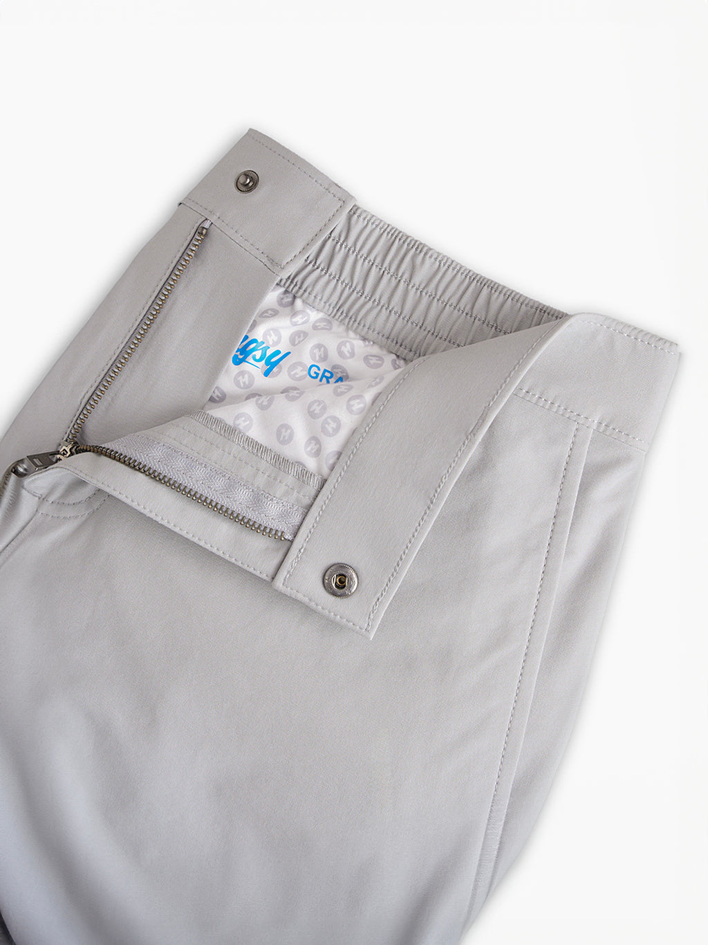 Light gray pants with zipper and snap button open to show inner lining with text 'easy GR'.