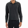 Male model wearing charcoal long-sleeve polo shirt and dark jeans on white background.