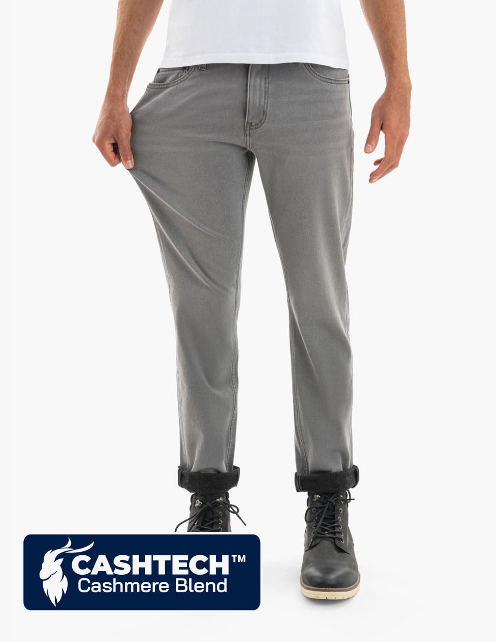 Gray slim-fit jeans being stretched at the thigh to show stretch; black boots visible; label: CASHTECH™ Cashmere Blend