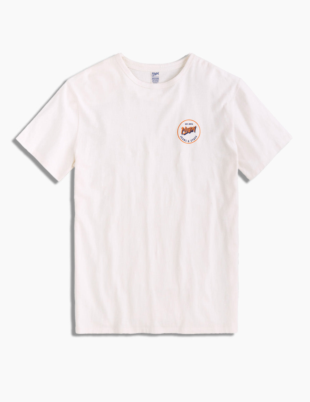 Flatlay of ivory Everyday Tee showing small round orange Mugsy chest logo, crew neck and short sleeves on white background