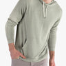 Front view of pine green cashmere and modal hoodie showing drawstring hood and kangaroo pocket on model wearing size Large
