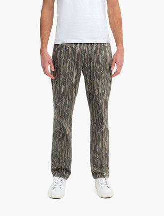 Front view of Realtree Originals Casual jeans showing Realtree camo print and relaxed casual fit on model against white background