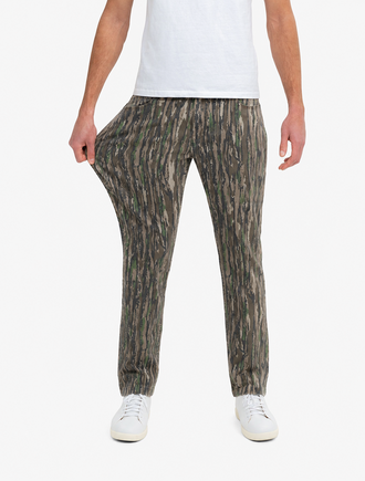 Front view of Realtree Originals camo jeans on model showcasing stretch fabric and relaxed classic Mugsy fit on white background