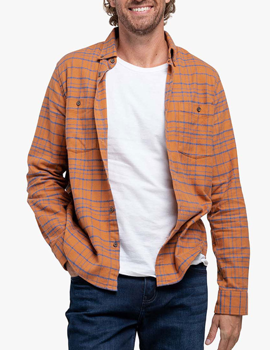 Man wearing an orange and blue checkered flannel shirt over a white t-shirt