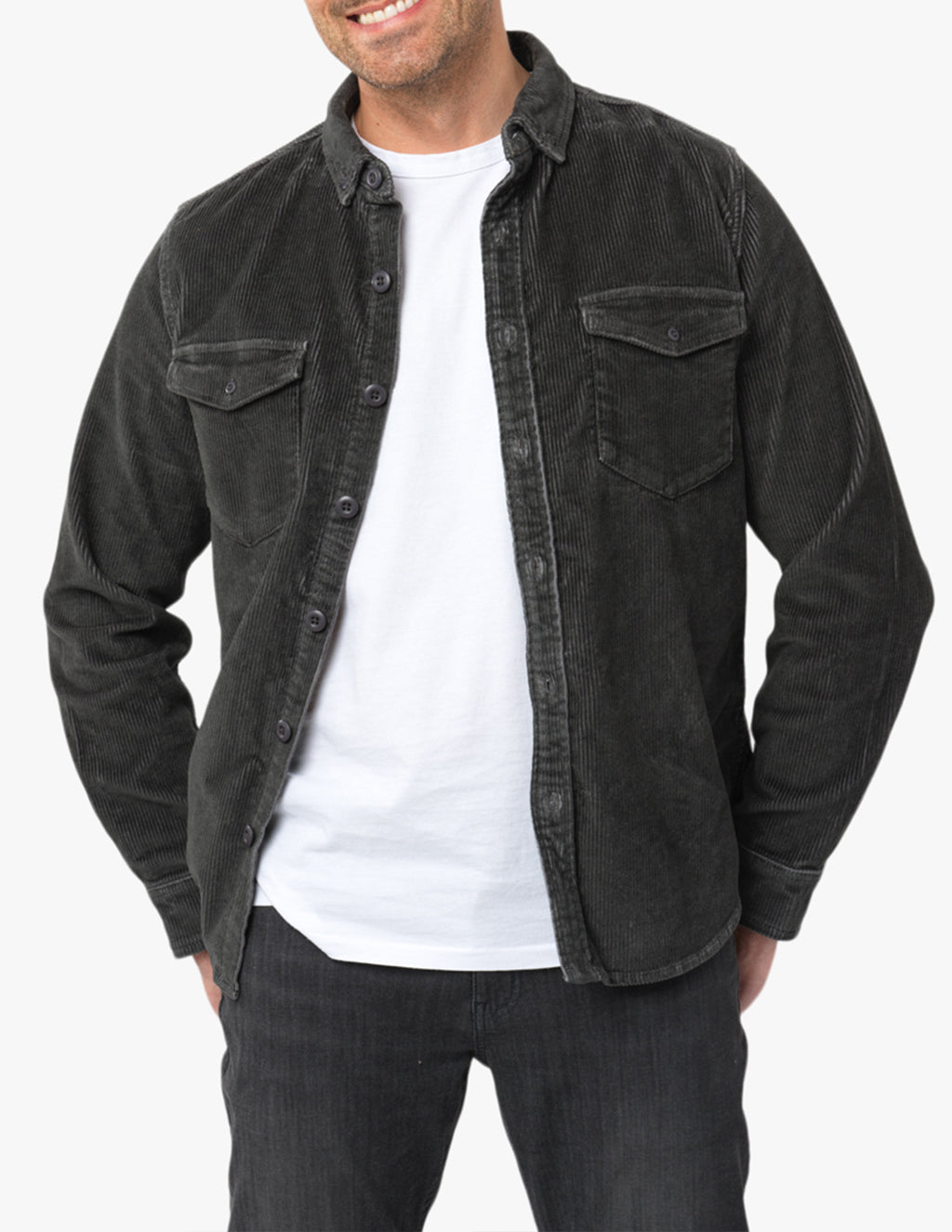 Model wearing a dark green corduroy shirt over a white t-shirt and black jeans.