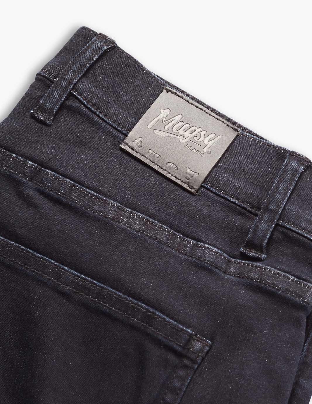 Close-up of Mugsy clutch jeans showing back pocket and tag in dark blue