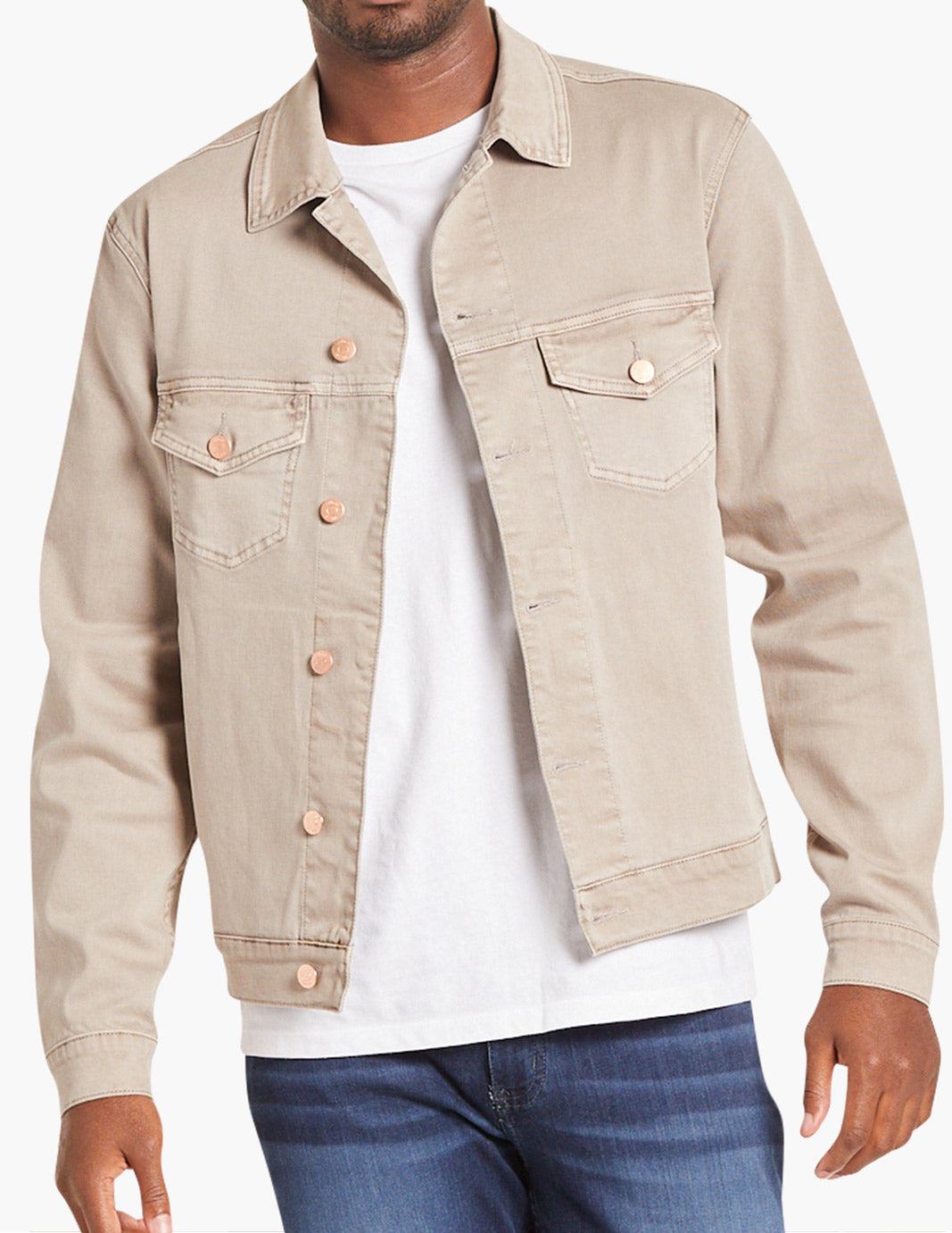 Model wearing a tan stretch denim jacket with button details and pockets.
