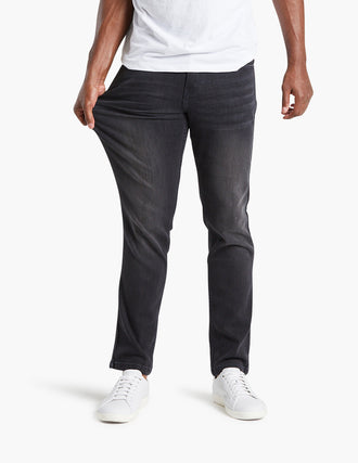 Model wearing stretch dark gray jeans, showcasing flexibility