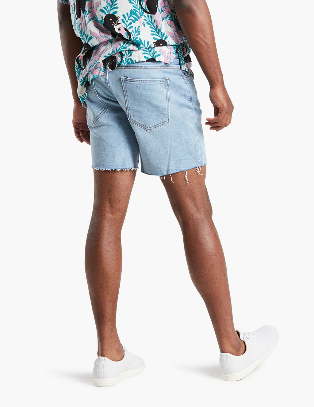 Model wearing vintage blue stretch jorts from the back