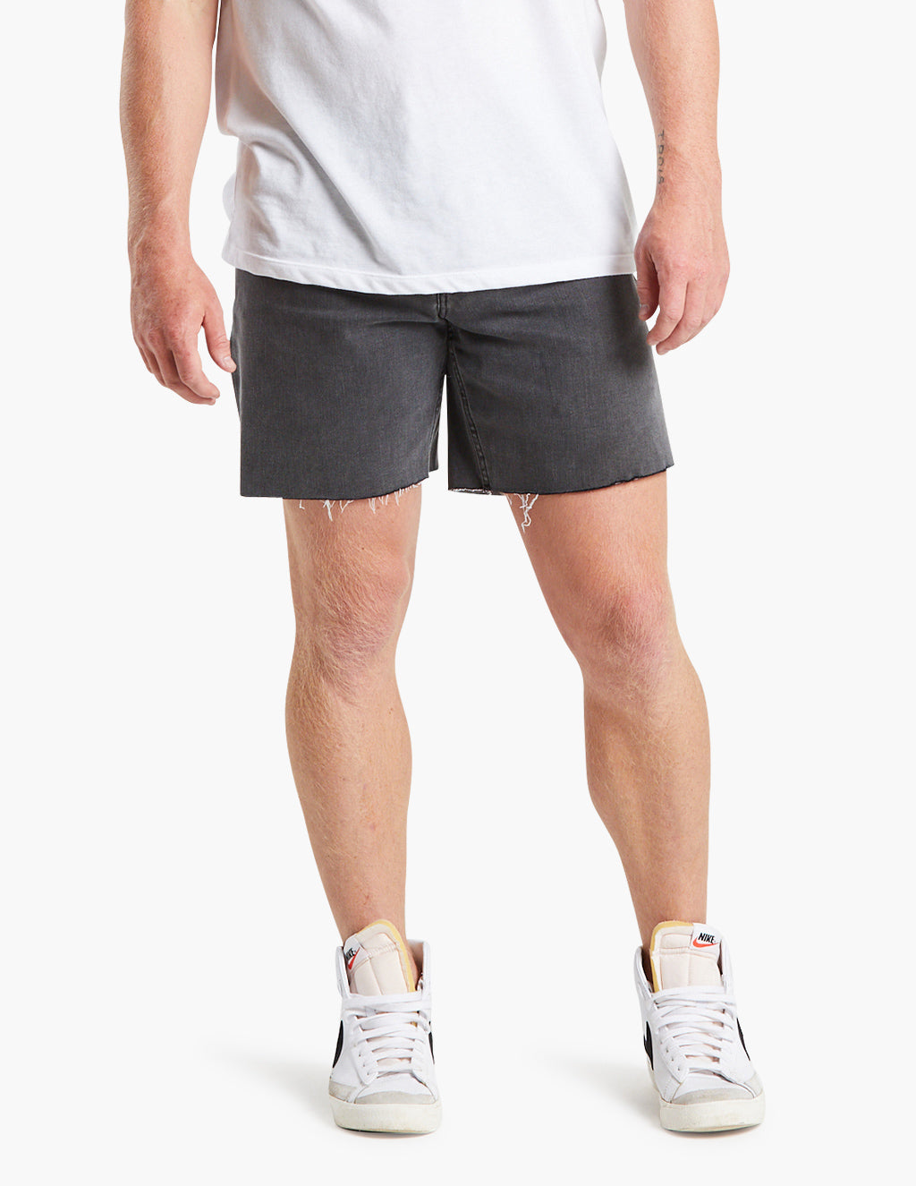 Model wearing gray black stretch denim jorts