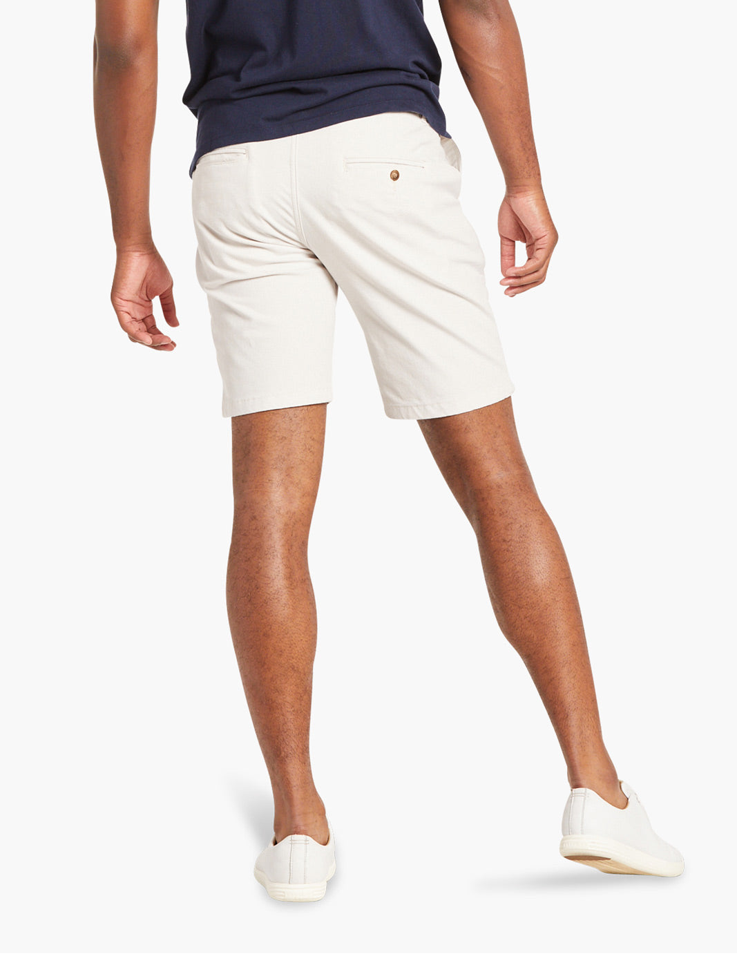 Back view of a person wearing white stretch chino shorts