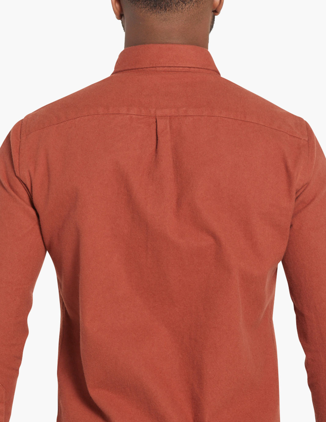 Back view of a burnt orange flannel shirt with a collar and button detail