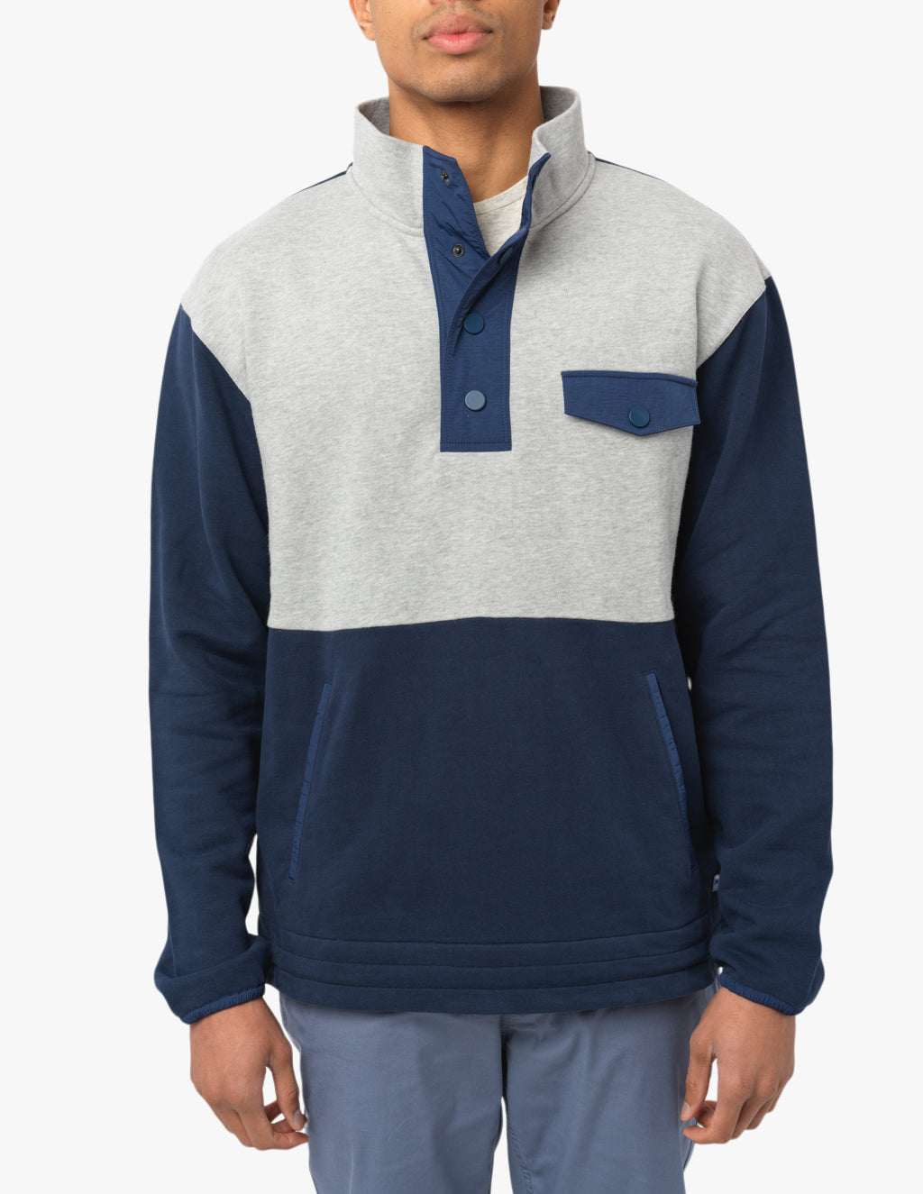 Model wearing a navy and gray quarter snap pullover with a chest pocket.