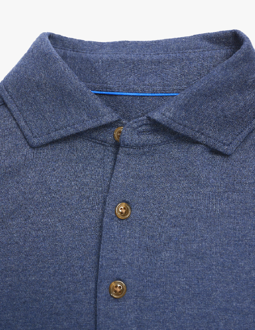 Close-up of a blue collared shirt with three brown buttons visible on the placket.