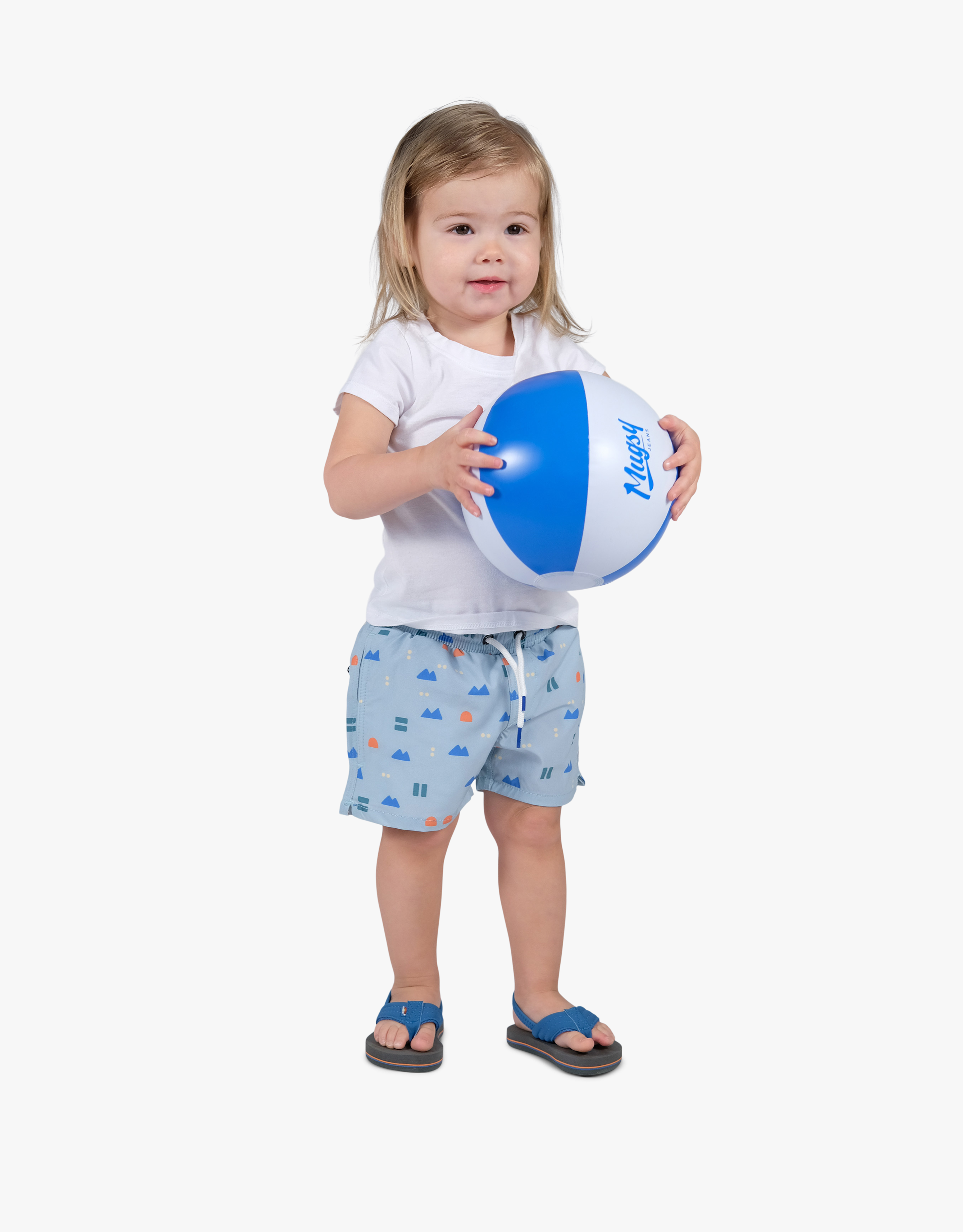 Child holding a blue beach ball, wearing light blue swim shorts with patterns.