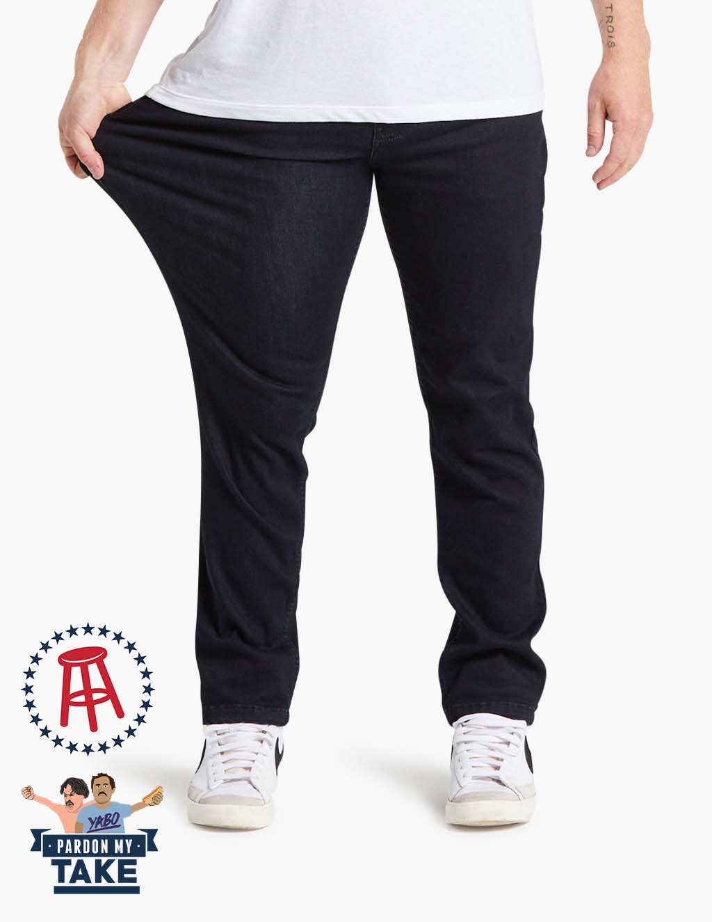 Person stretching dark blue Mugsy clutch jeans, featuring Barstool logo and Pardon My Take branding
