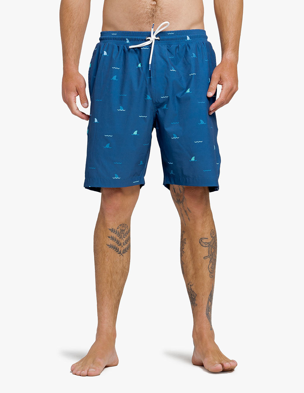 Men's navy swim trunks with shark pattern, part of a promotional offer for free hat with purchase.