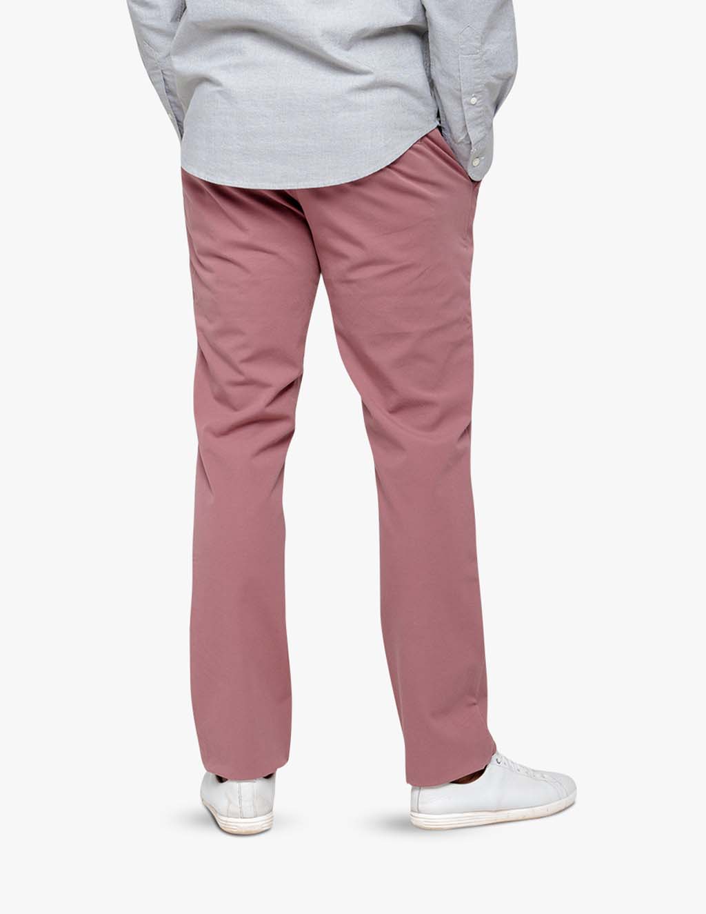 Model wearing washed red men's stretch chinos from the back, showcasing fit and style.